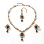 Detail flatlay of the silver-tone noir kundan necklace and matching earrings with black accents