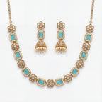 Studio flatlay of the aqua necklace set with matching earrings.