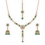 Studio flatlay of the emerald heirloom necklace set with matching earrings.
