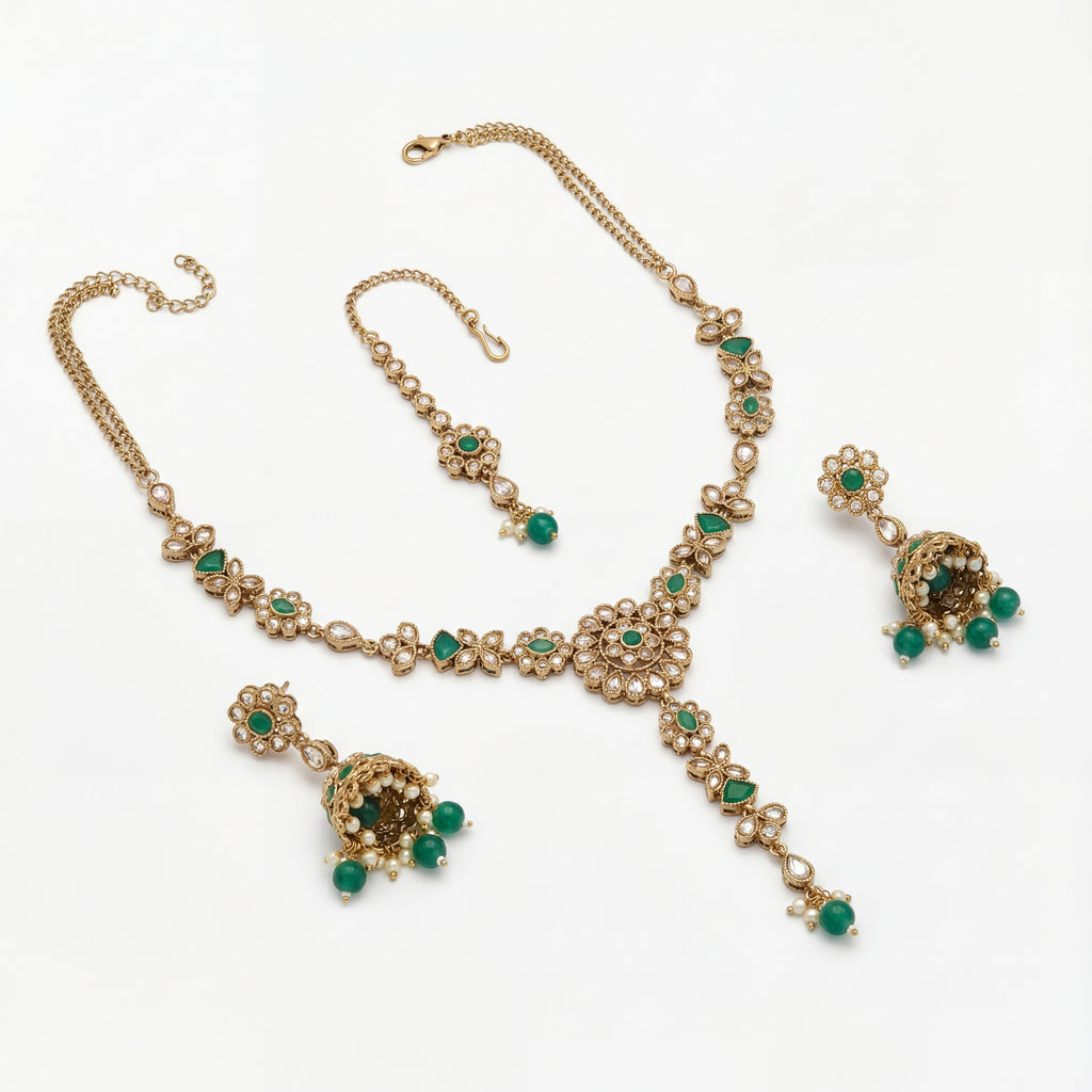 South Asian woman wearing the emerald heirloom necklace set — bridal look.