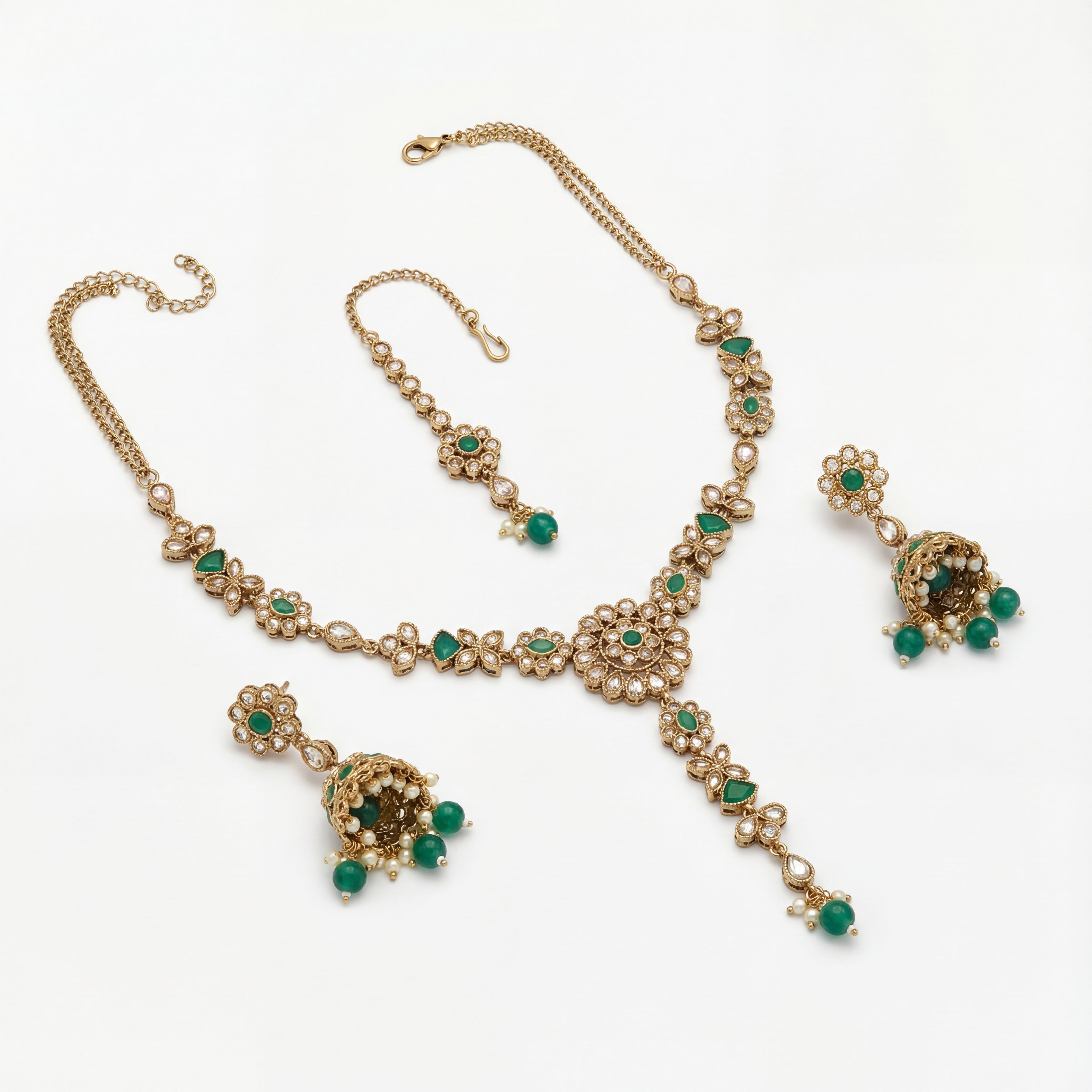 South Asian woman wearing the emerald heirloom necklace set — bridal look.