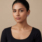 Close-up of Ruhani Pink Glow Stud Earrings showing rich jewel-toned accents and gold-plated finish