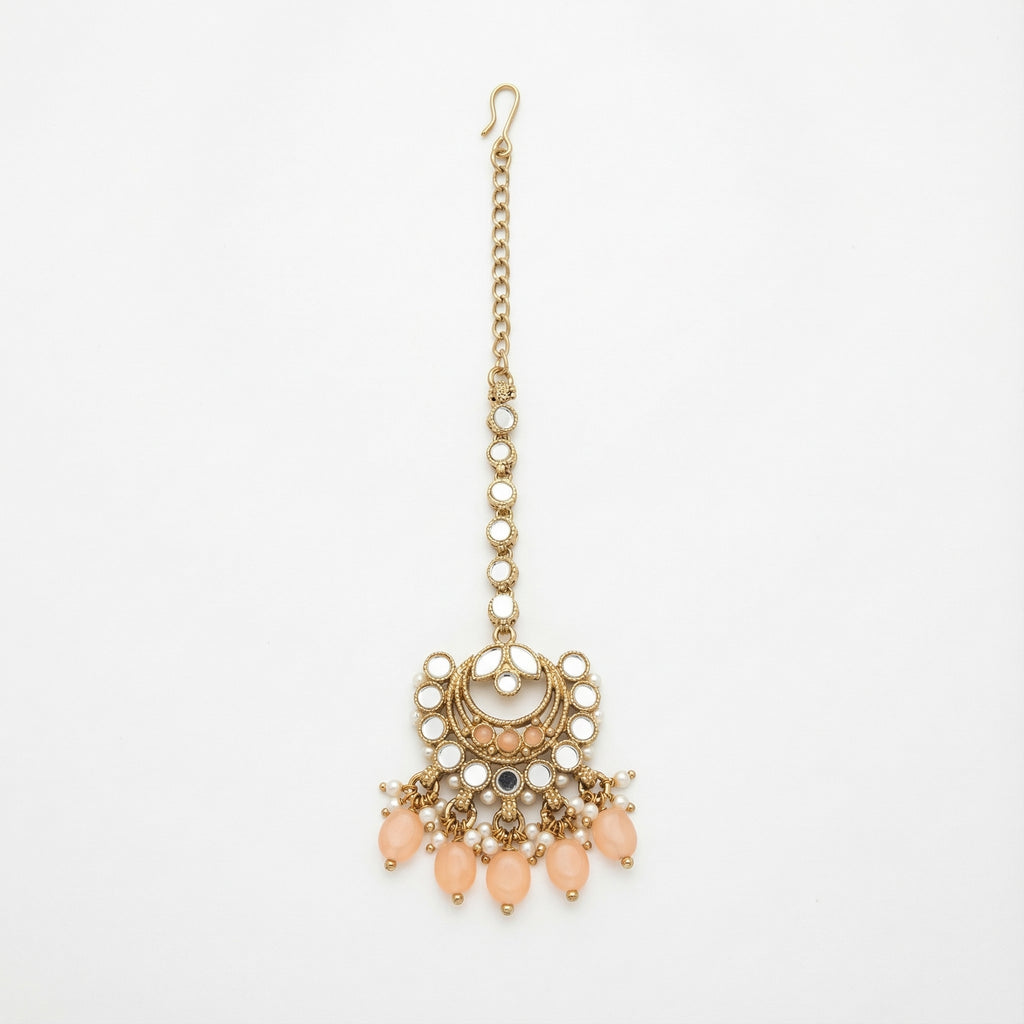 Ziya Crescent Tikka gold maang tikka with mirror kundan links and peach crescent pendant on gray background
