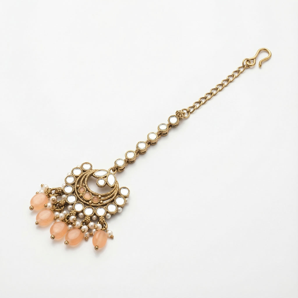 Ziya Crescent Tikka detail showing mirror stem, peach crescent center, and peach bead drop fringe