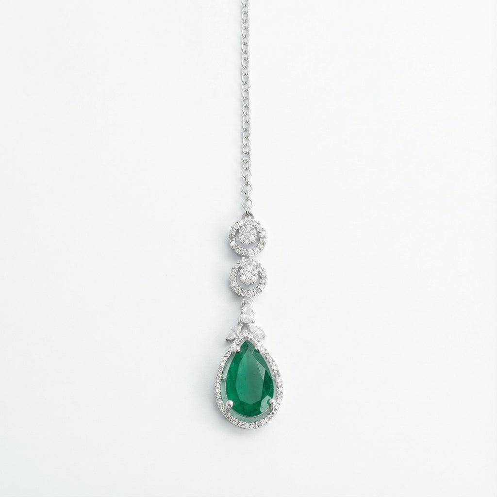 Zayna Emerald Statement Tikka silver-tone chain with emerald pear halo pendant on white background