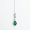 Zayna Emerald Statement Tikka silver-tone chain with emerald pear halo pendant on white background