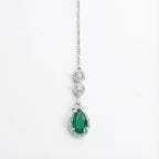 Zayna Emerald Statement Tikka silver-tone chain with emerald pear halo pendant on white background