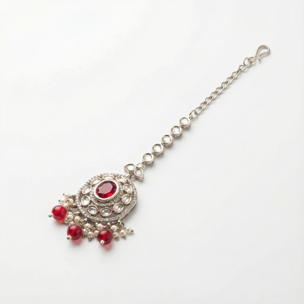 Saffiya Ruby Polki Tikka detail showing radial clear stones, red oval center, and dangling red beads