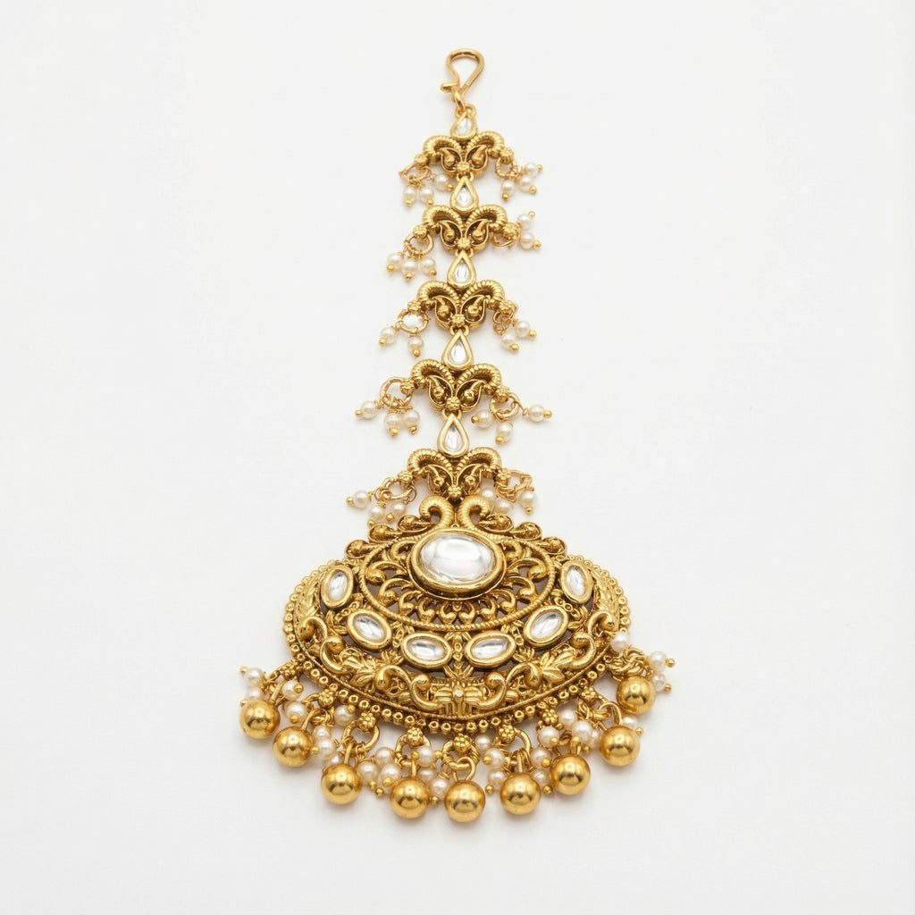 Chandrika Pearl Crest Tikka gold-tone kundan maang tikka with pearl fringe on gray background