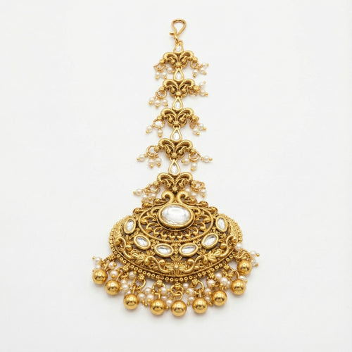 Chandrika Pearl Crest Tikka gold-tone kundan maang tikka with pearl fringe on gray background