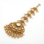 Chandrika Pearl Crest Tikka detail of oval clear center and embossed floral crest pendant