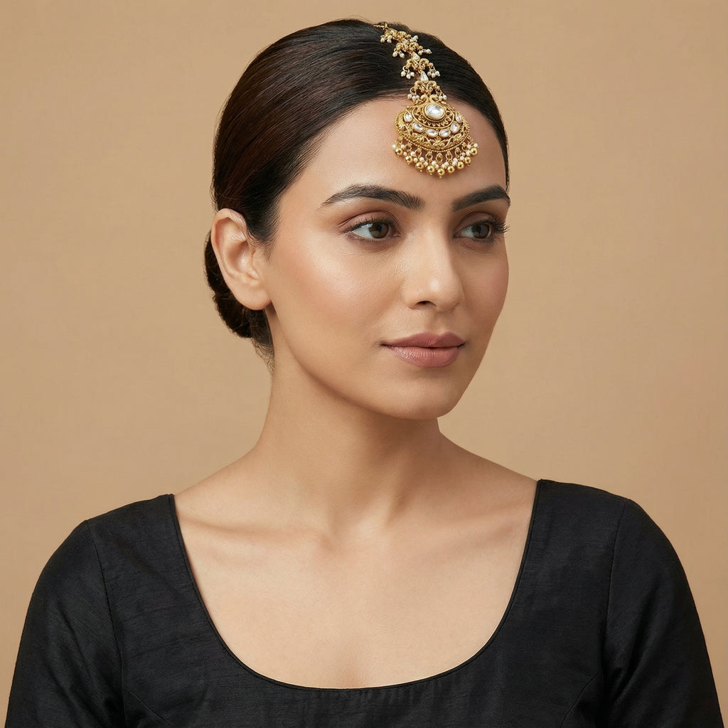 Chandrika Pearl Crest Tikka detail of oval clear center and embossed floral crest pendant