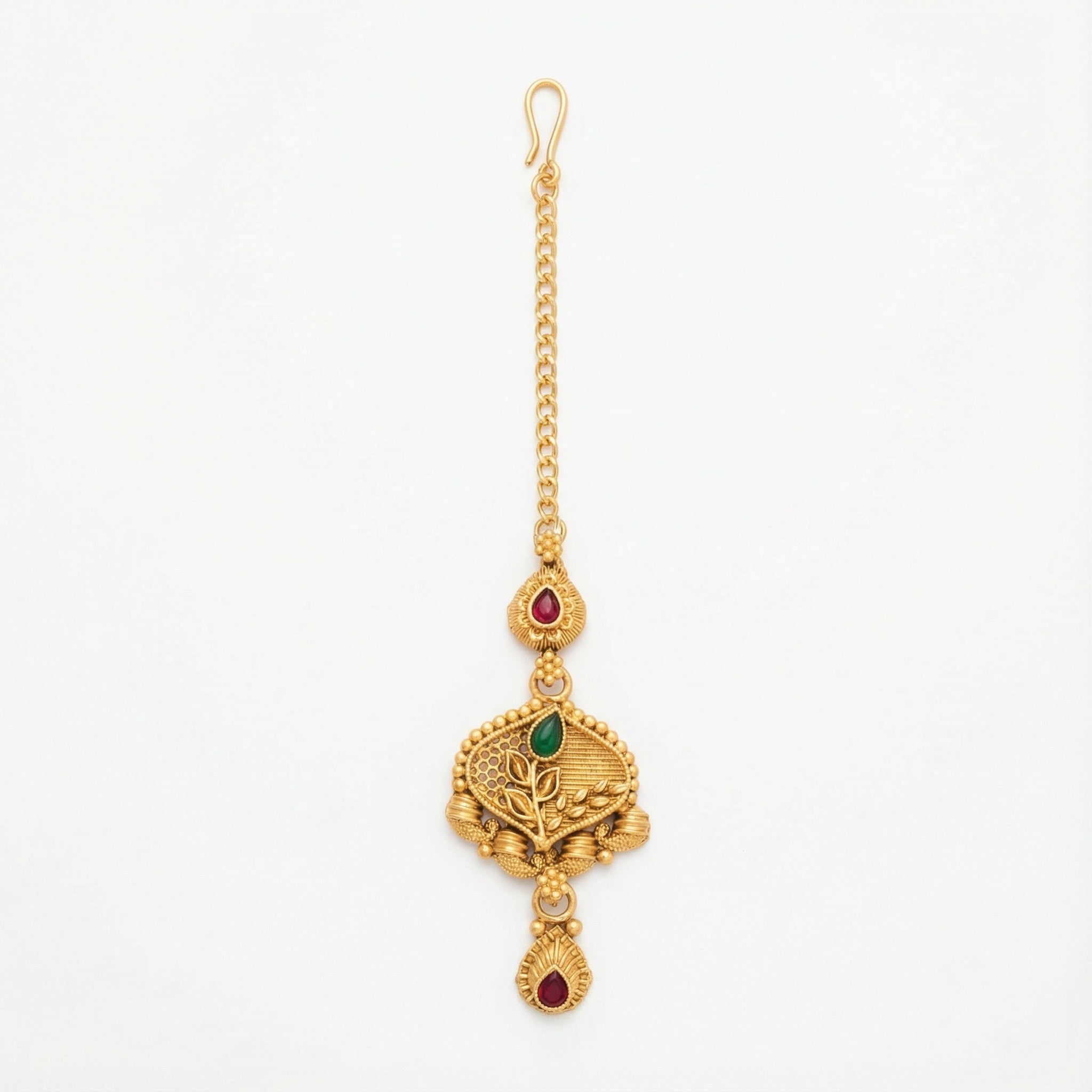 Ishara Leaf Crest Tikka antique gold maang tikka with green and red teardrop stones on gray background