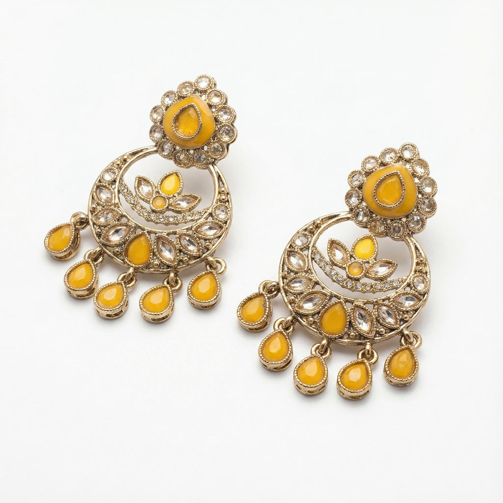 Haldi Crest Statement Earrings detail showing crescent lotus panel and yellow teardrop fringe