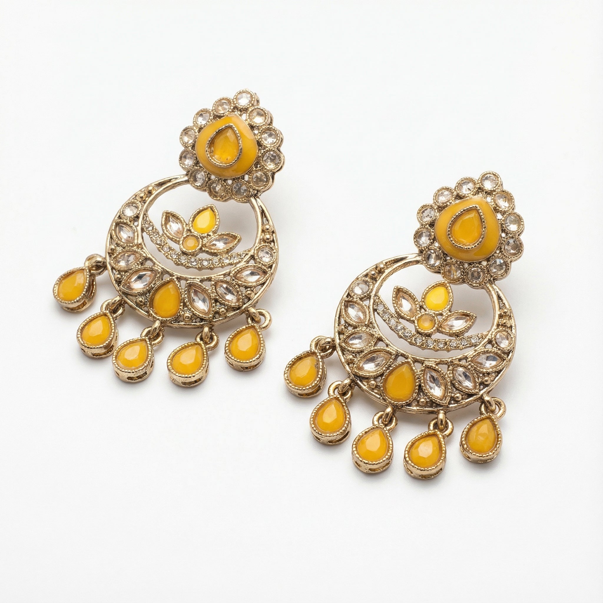 Haldi Crest Statement Earrings detail showing crescent lotus panel and yellow teardrop fringe