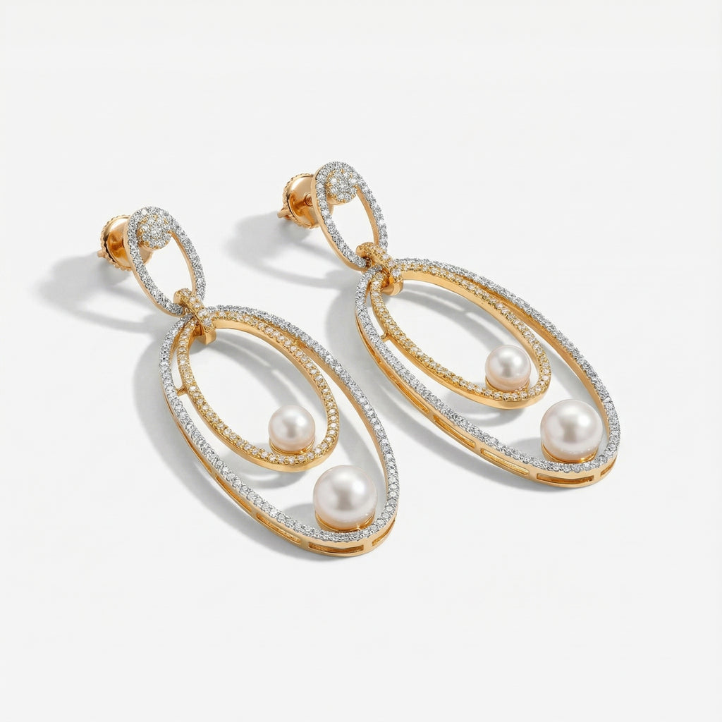 Orbitline Drop Earrings detail showing rhodium outer hoop, gold inner oval, and graduated pearl drops