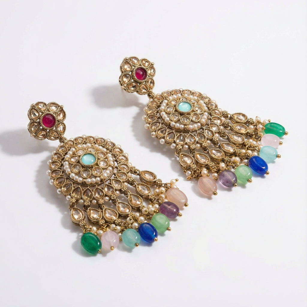Navya Festival Earrings detail showing ruby polki stud, pearl-bordered medallion, and colorful bead dangles