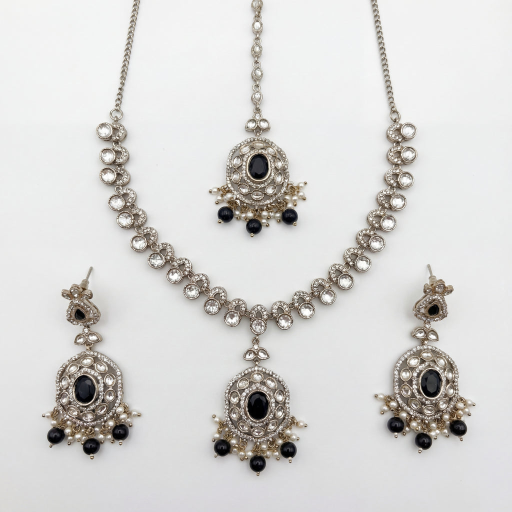 Eclipse Polki Necklace Set silver pendant necklace with black stones, earrings, and maang tikka on white background