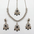 Eclipse Polki Necklace Set silver pendant necklace with black stones, earrings, and maang tikka on white background