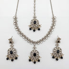 Eclipse Polki Necklace Set silver pendant necklace with black stones, earrings, and maang tikka on white background