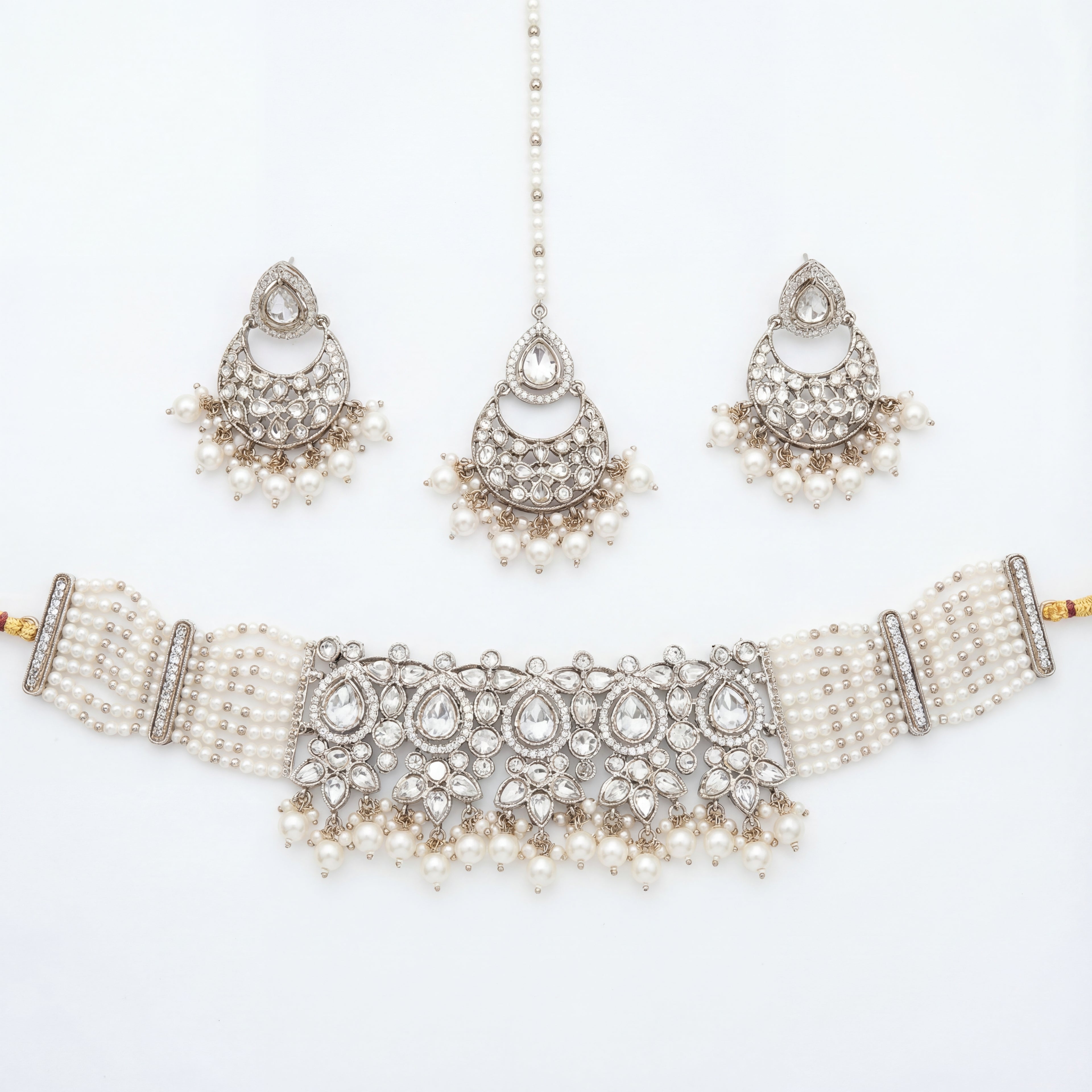 Saaya Pearl Choker Necklace Set silver choker with pearl strands, chandbali earrings, and maang tikka on white background