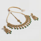 Utsav Emerald Polki Necklace Set detail of emerald polki motifs and green latkan fringe