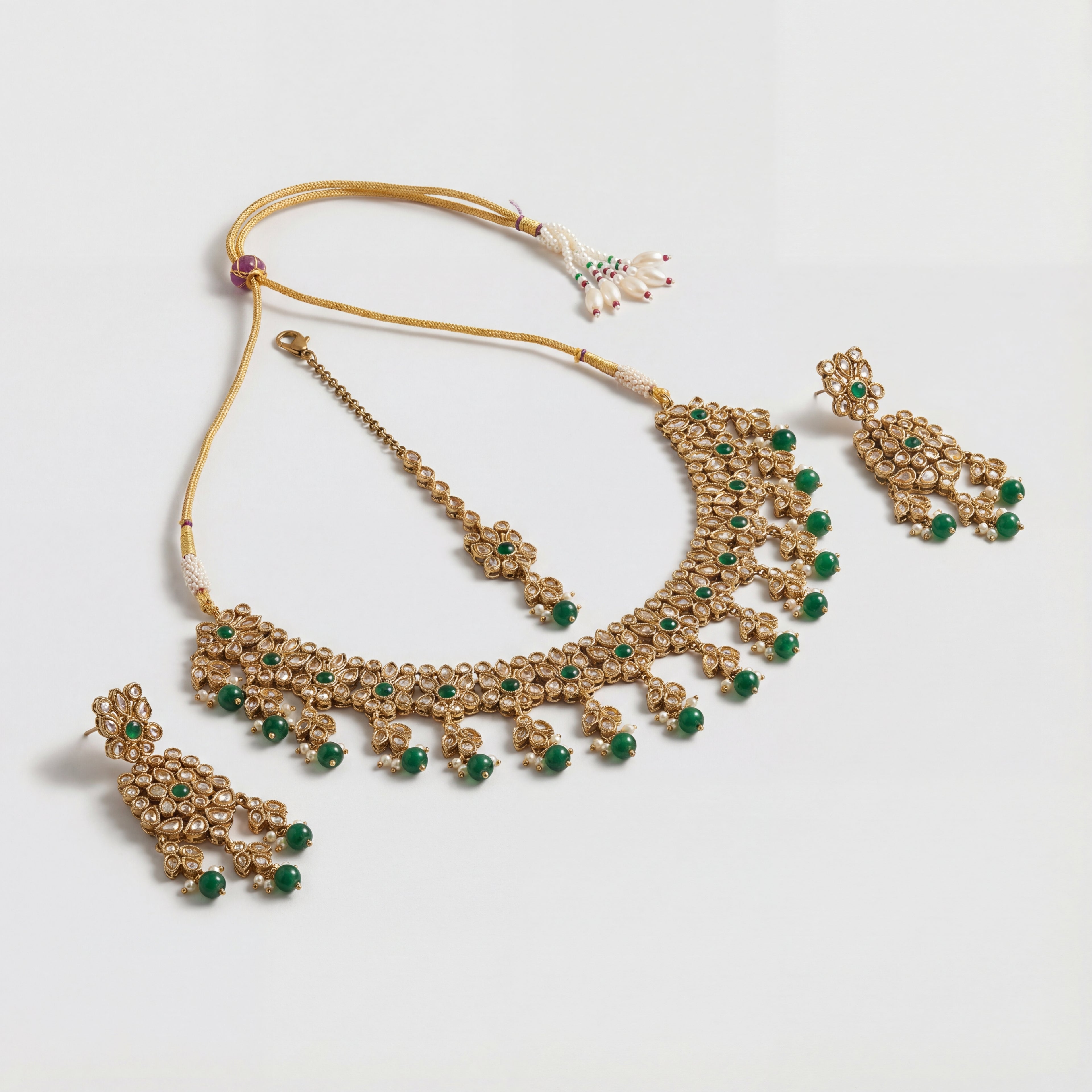Utsav Emerald Polki Necklace Set detail of emerald polki motifs and green latkan fringe