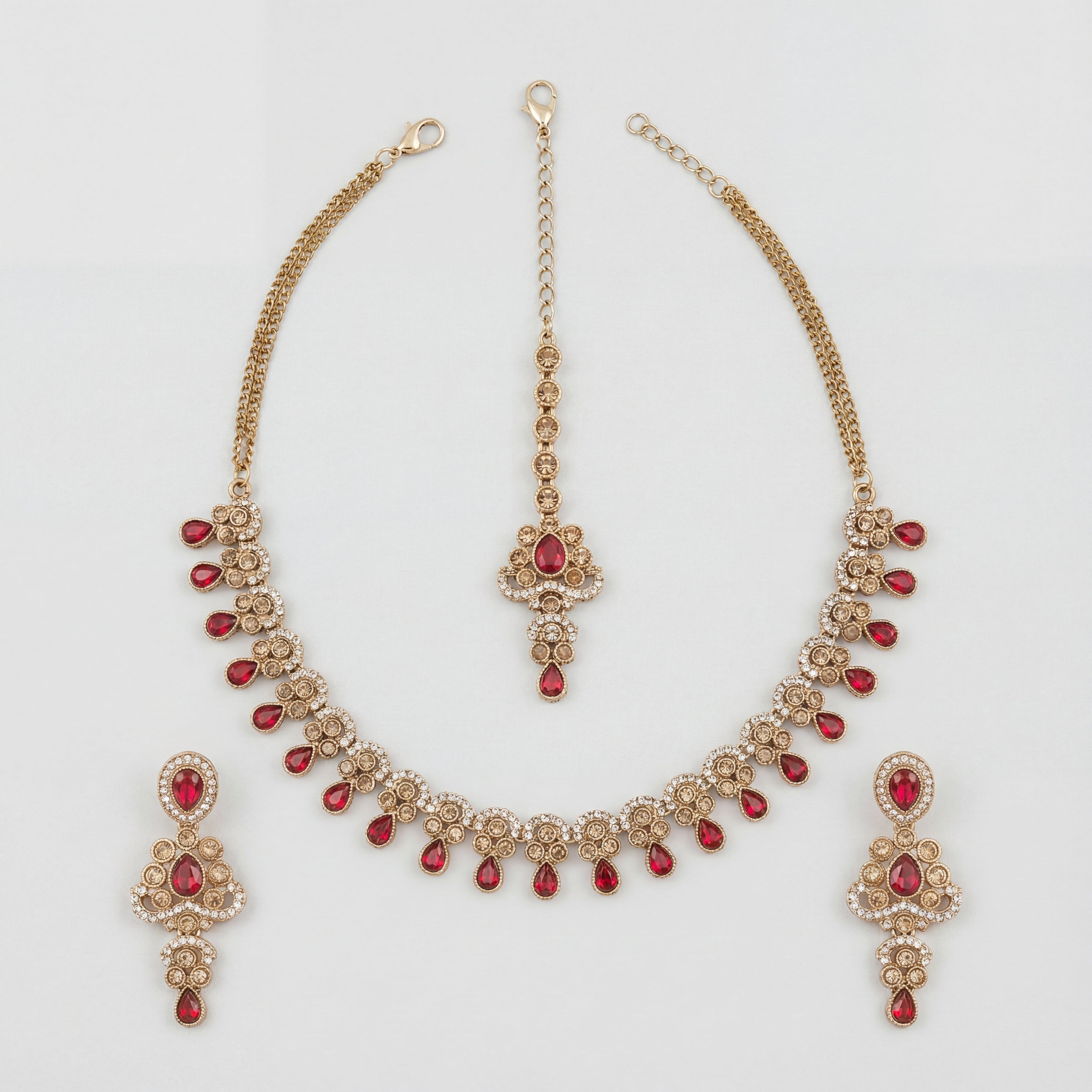 Zeenat Ruby Polki Necklace Set gold bib necklace with ruby fringe, earrings, and maang tikka on white background