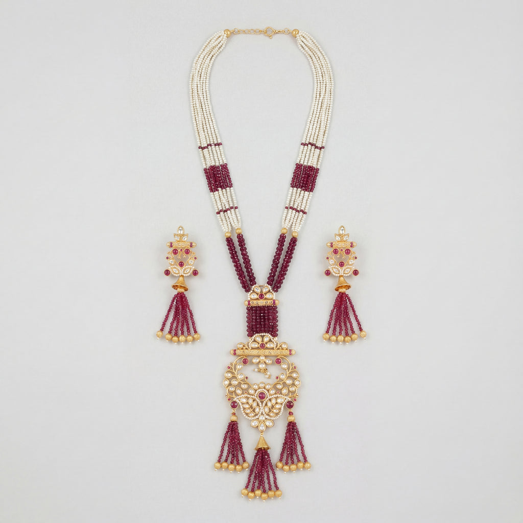 Shahi Ruby Polki Grand Necklace Set gold Rani haar with ruby beads and polki pendant on gray background