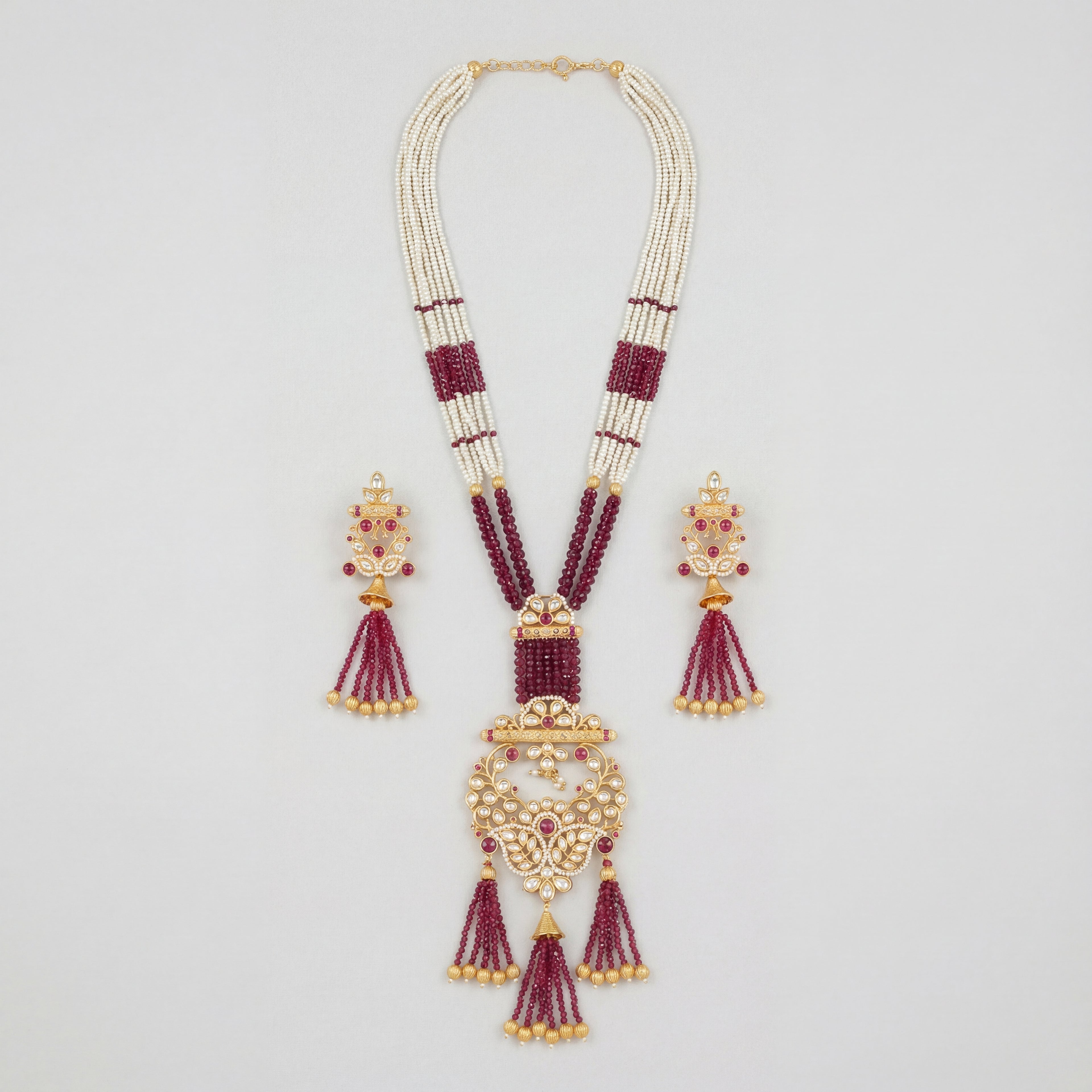 Shahi Ruby Polki Grand Necklace Set gold Rani haar with ruby beads and polki pendant on gray background