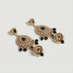 Onyx Noor Jhumka Earrings detail showing filigree sunburst panel and pearl-lined bell