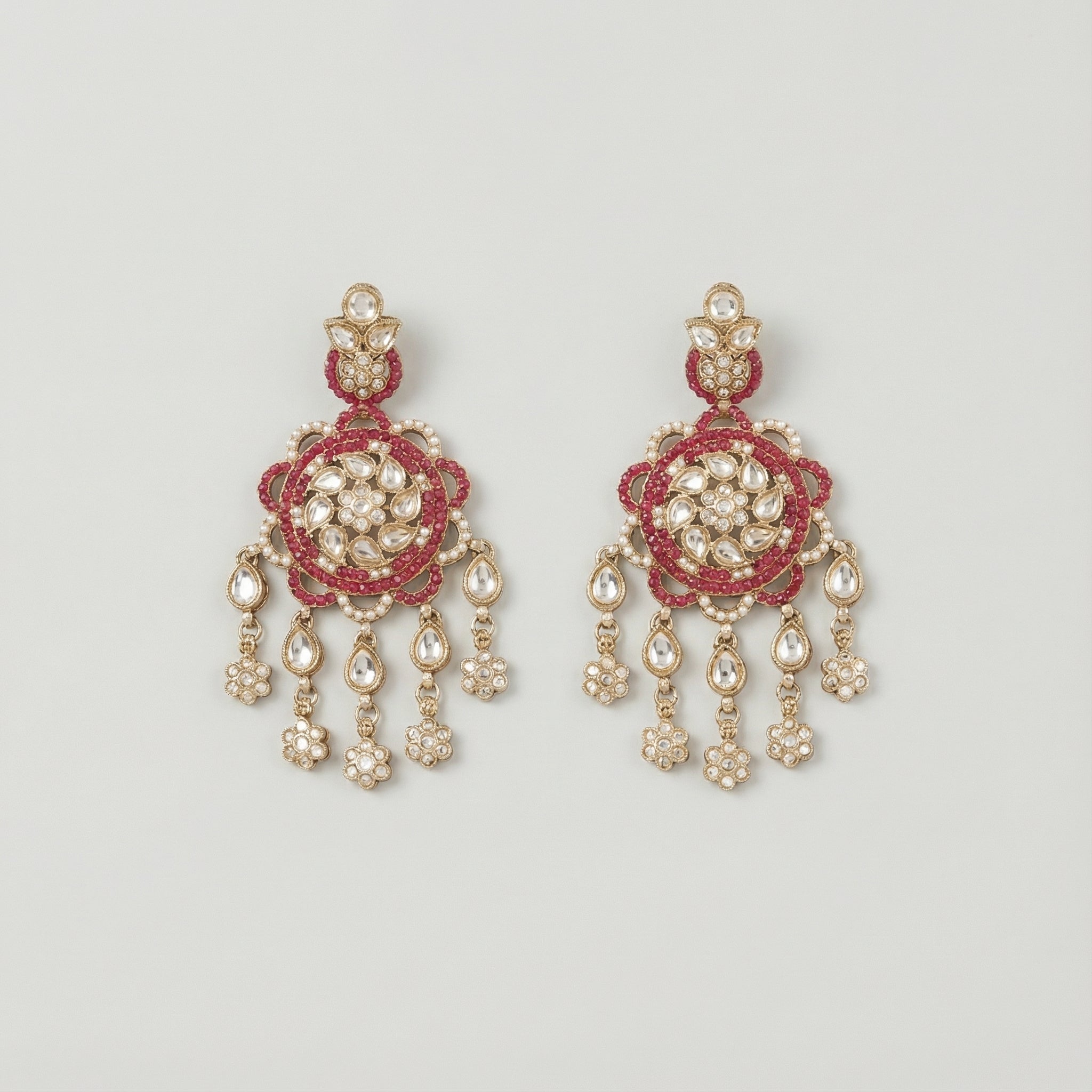 Rani Kundan Cascade Earrings gold kundan chandelier with ruby border and pear fringe on gray background