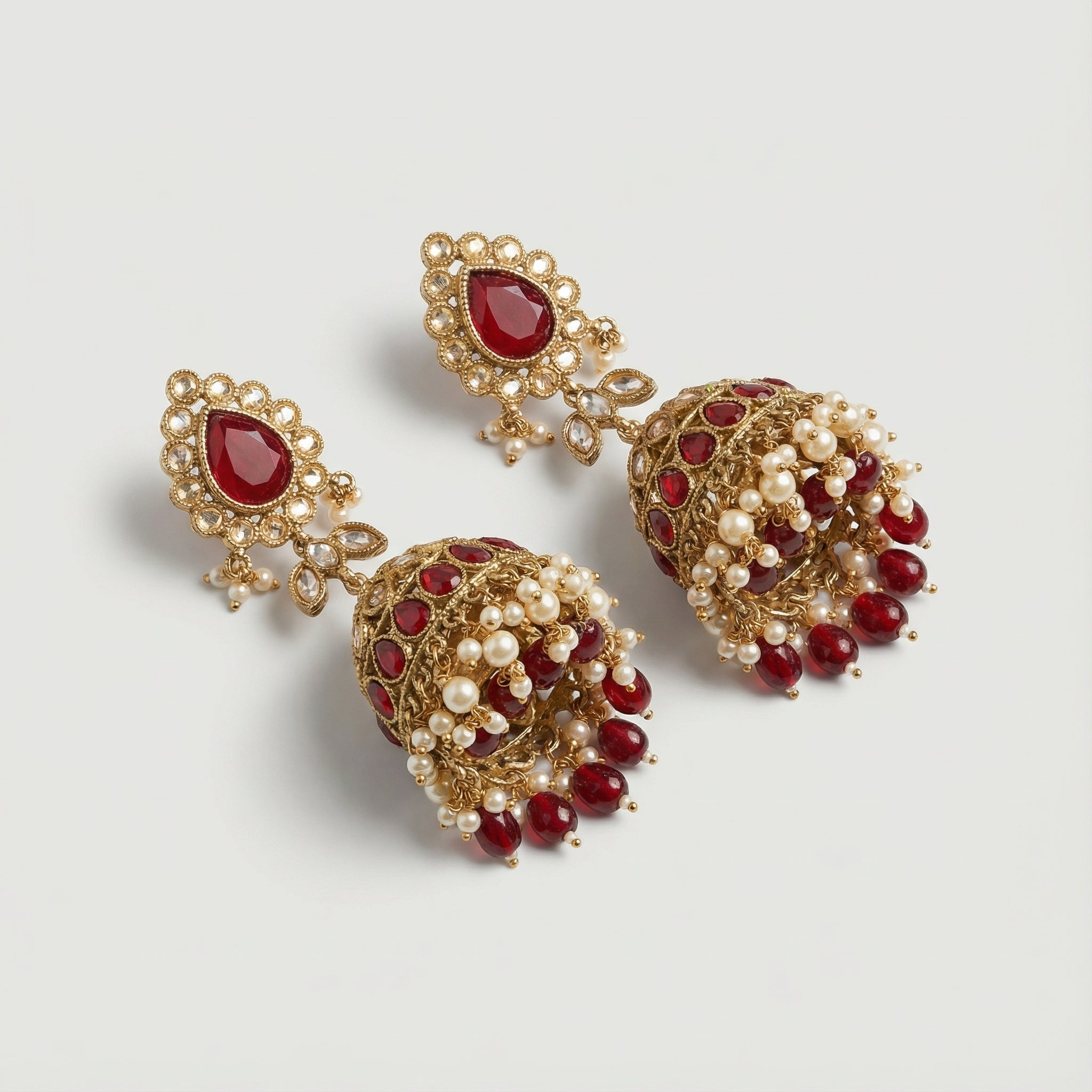 Noor Mahal Ruby Jhumka Earrings detail showing ruby stud halo and bell teardrop band