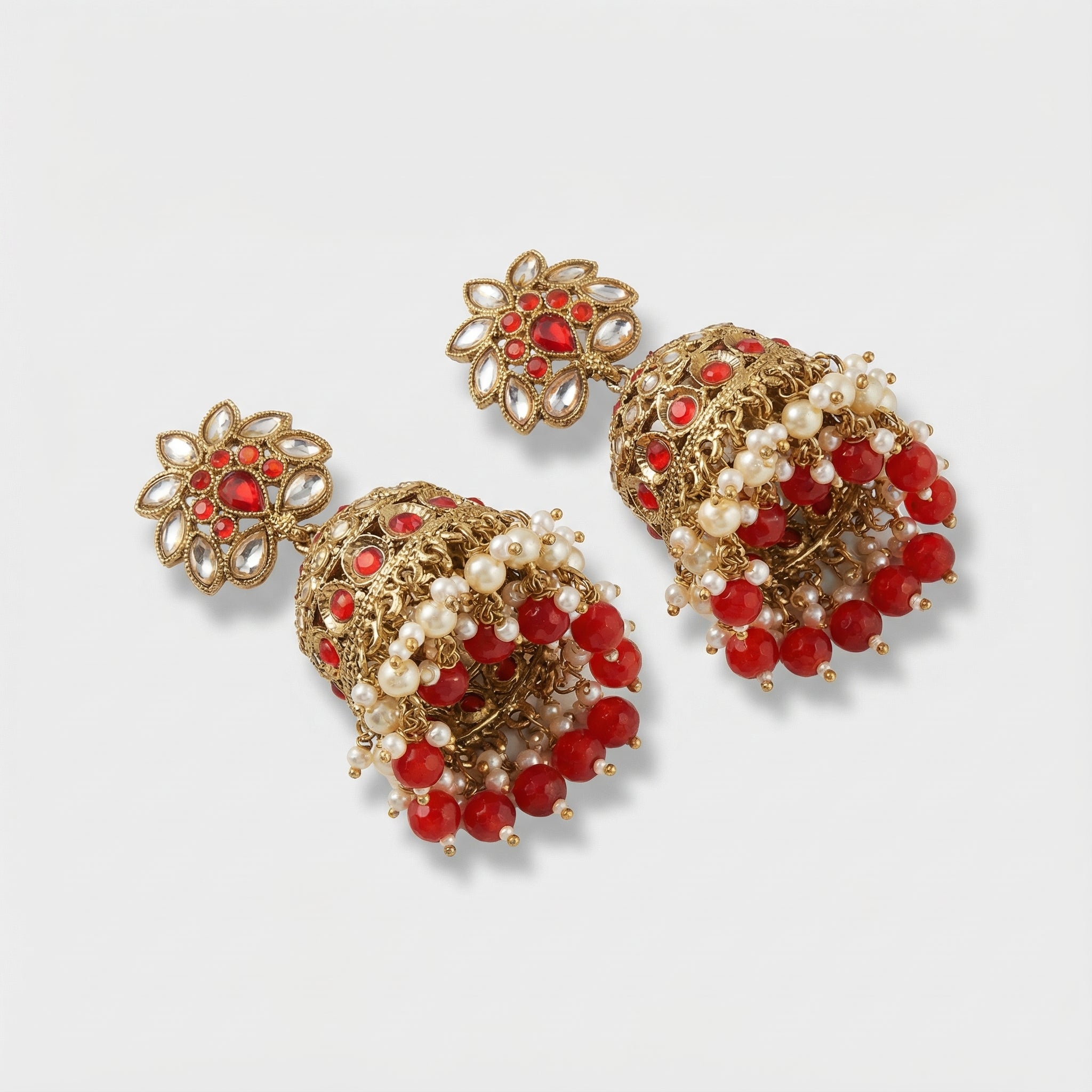 Crimson Noor Pearl Jhumkas detail showing ruby dome band and pearl-ruby drop fringe