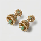 Pista Kundan Pearl Jhumka Earrings detail showing mint floral stud and bell dome accents