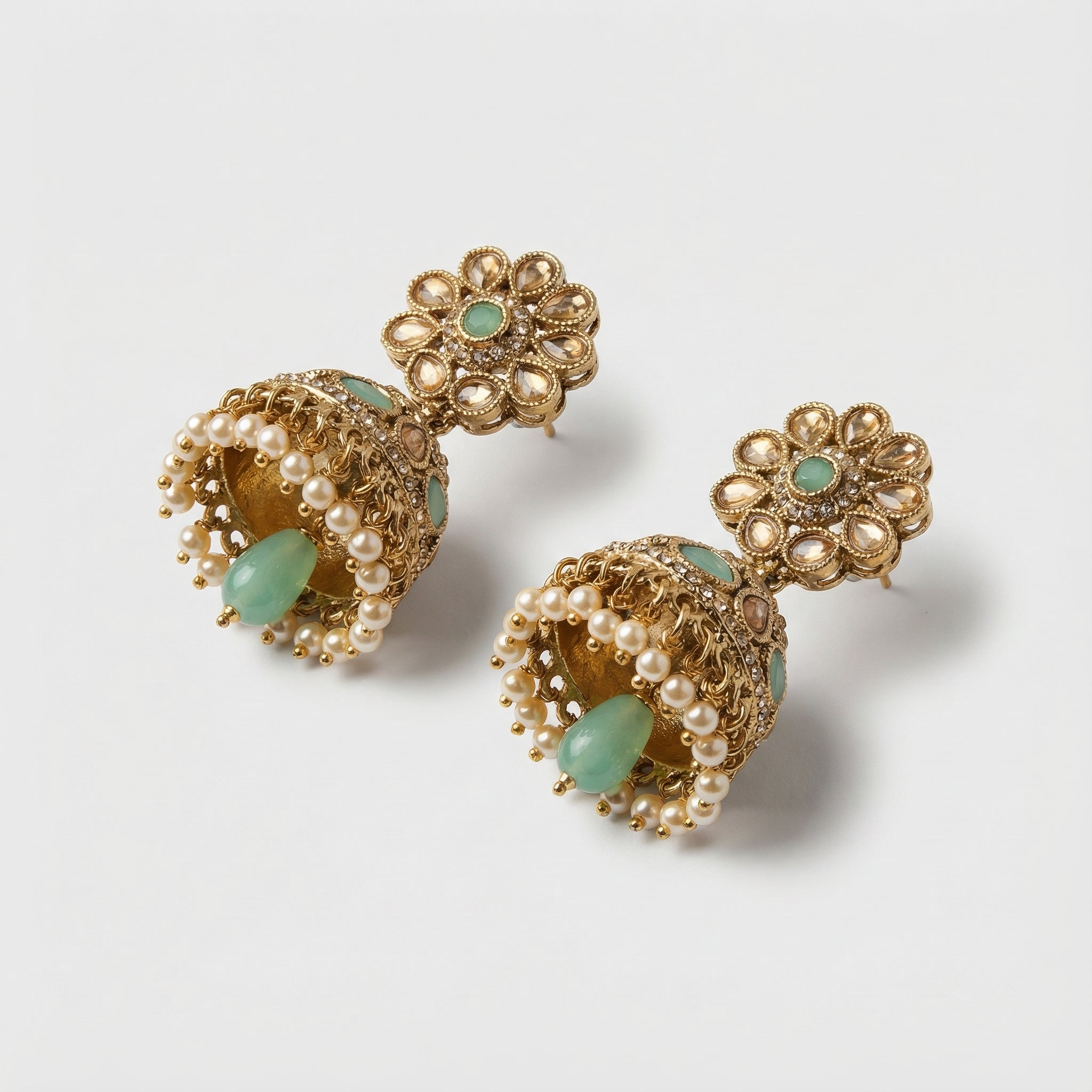 Pista Kundan Pearl Jhumka Earrings detail showing mint floral stud and bell dome accents