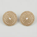 Golden Noor Disc Earrings large gold-tone circular crystal stud earrings on gray background