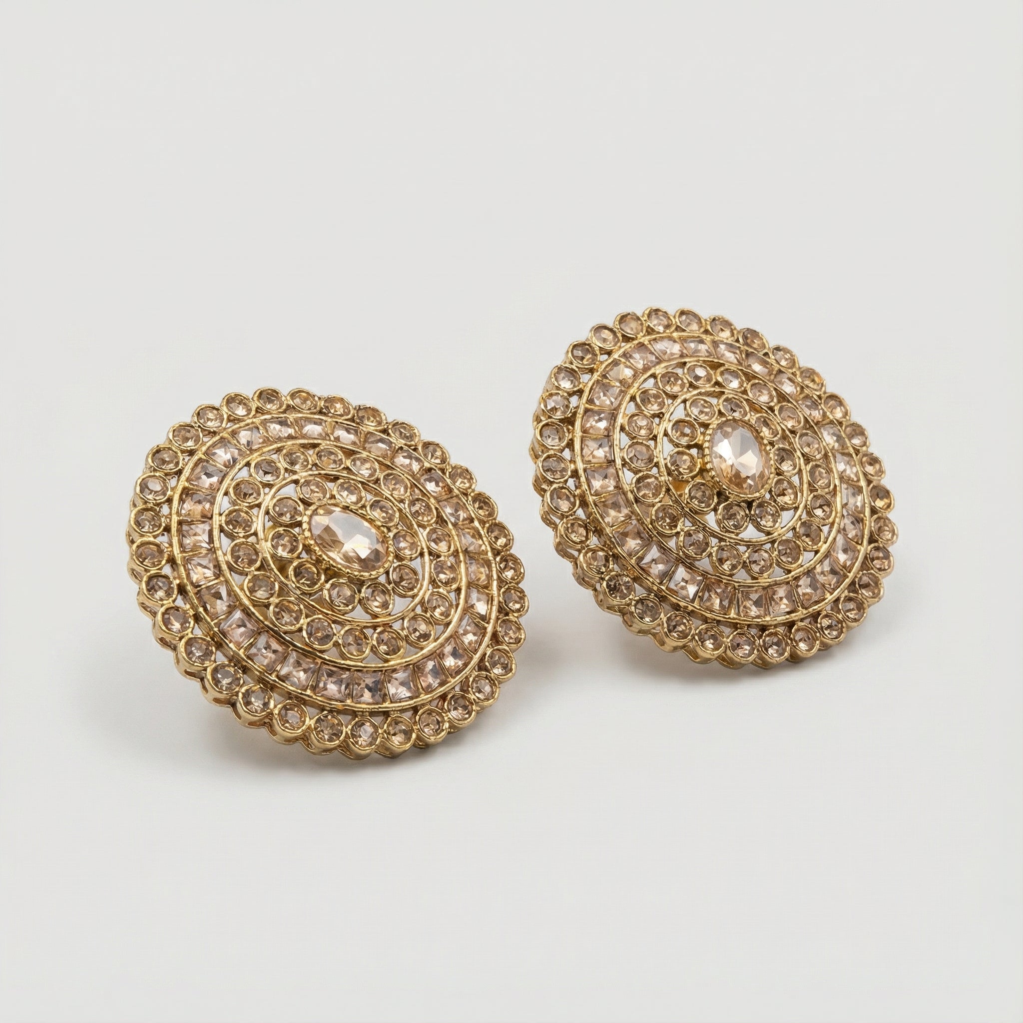 Golden Noor Disc Earrings detail showing oval center baguette rings and scalloped crystal border