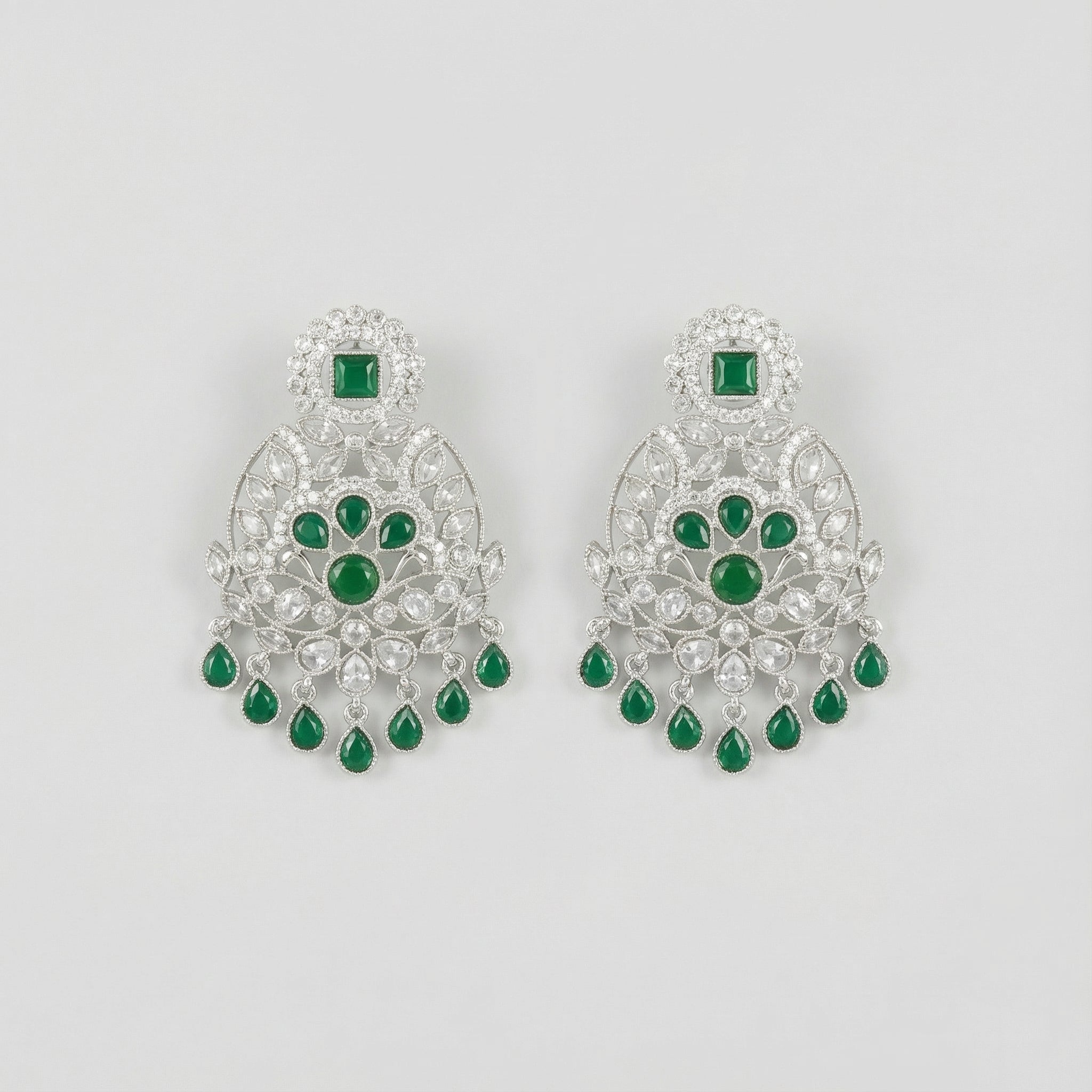 Emerald Chandni Statement Earrings rhodium filigree chandelier with emerald drops on gray background