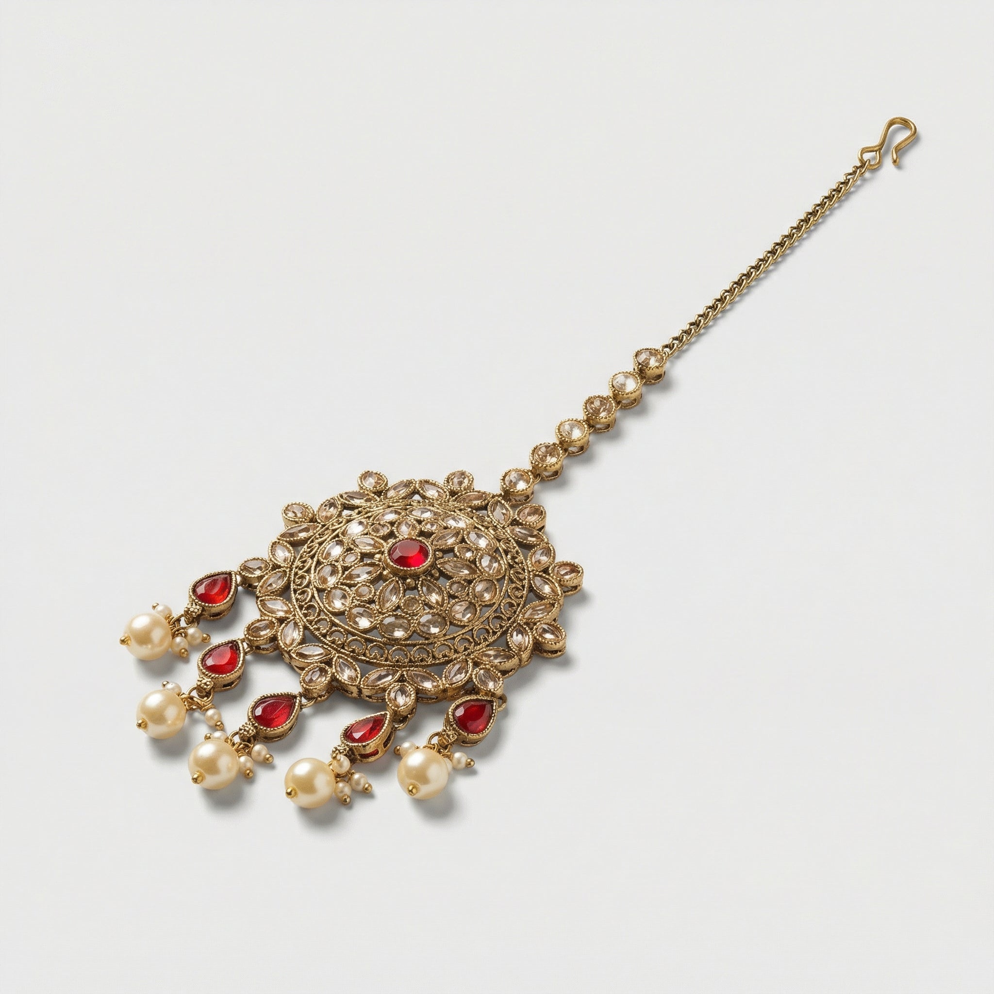 Noor Mahal Ruby Tikka detail showing filigree ruby medallion and teardrop fringe