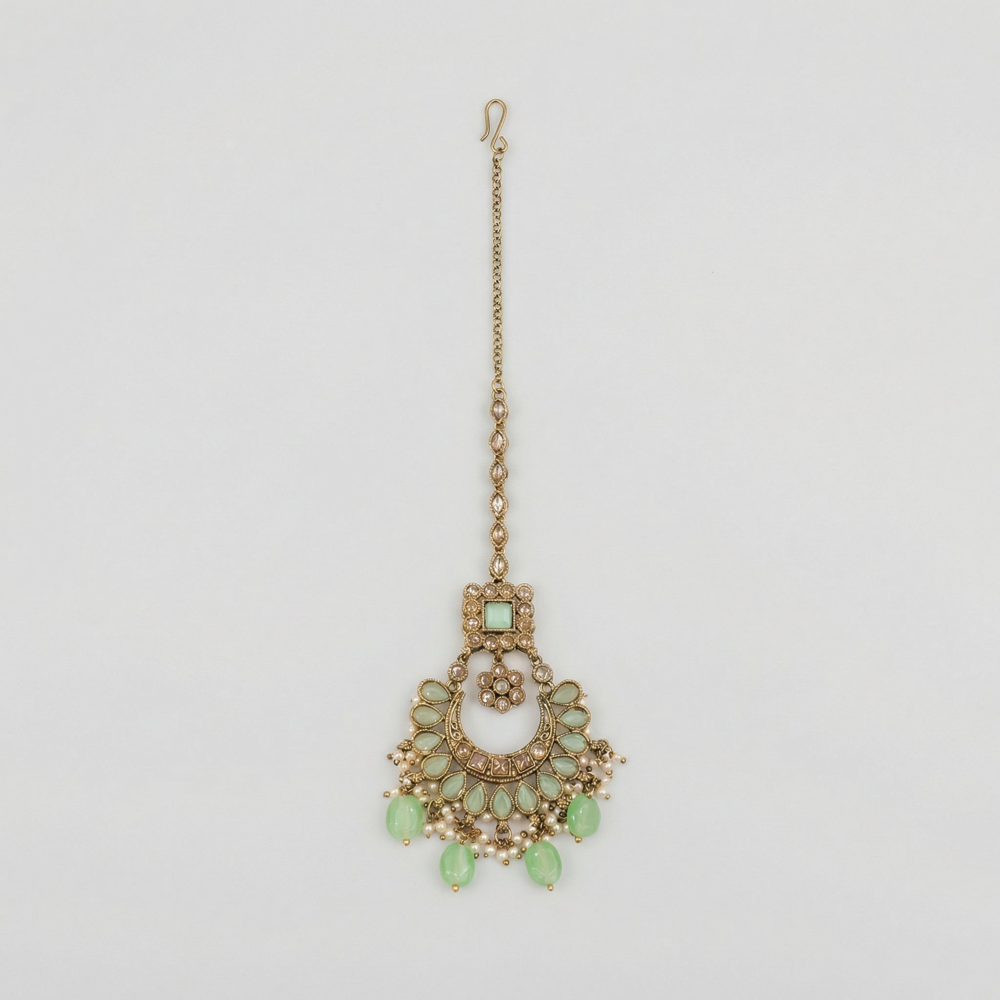 Mint Pearl Drop Tikka antique gold chaandbali maang tikka with mint stones and pearl fringe on gray background