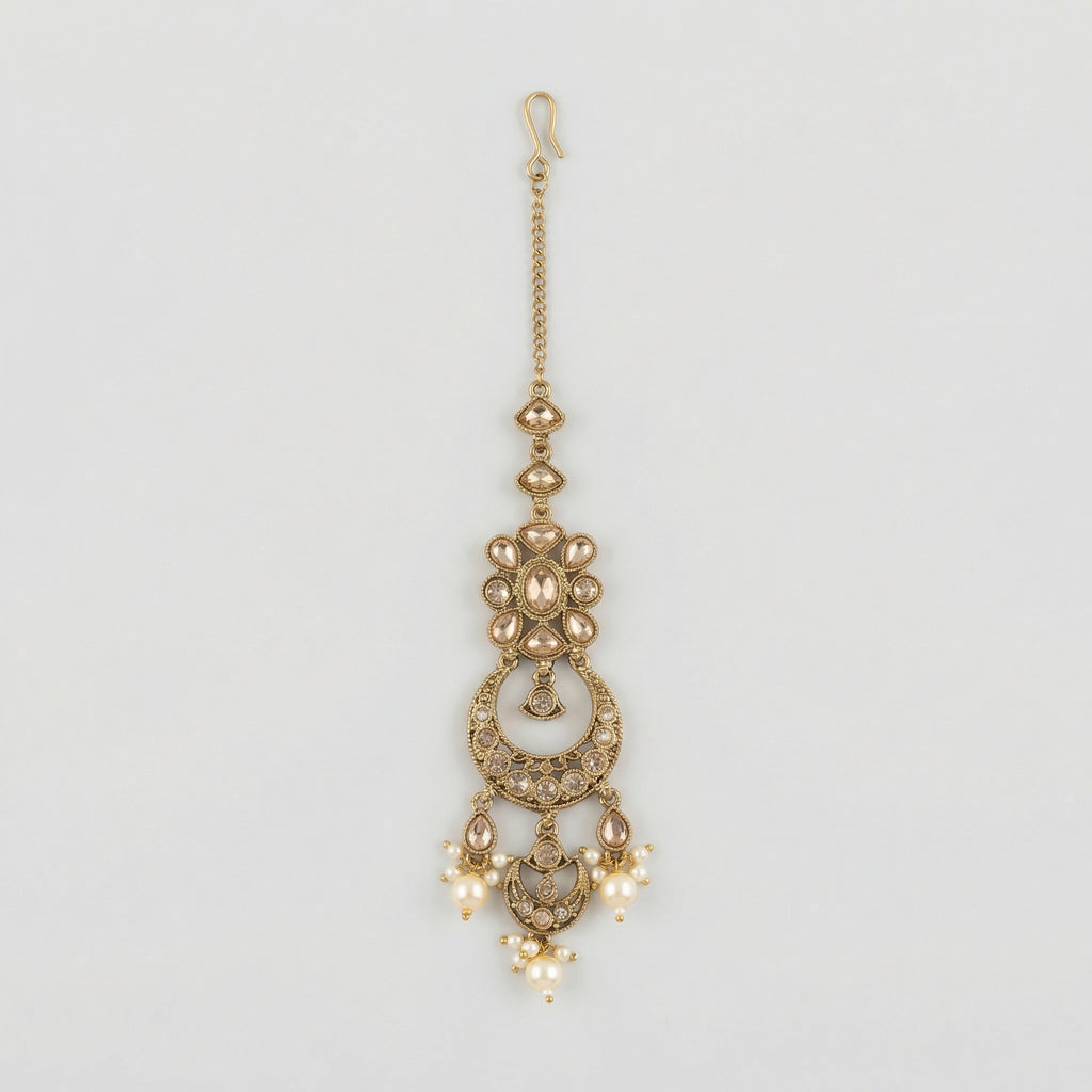 Ivory Aura Kundan Tikka antique gold chandbali maang tikka with kundan crescent and pearl drops on gray background