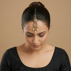 Ivory Aura Kundan Tikka detail showing floral kundan cluster, ornate crescent, and pearl-tipped drops