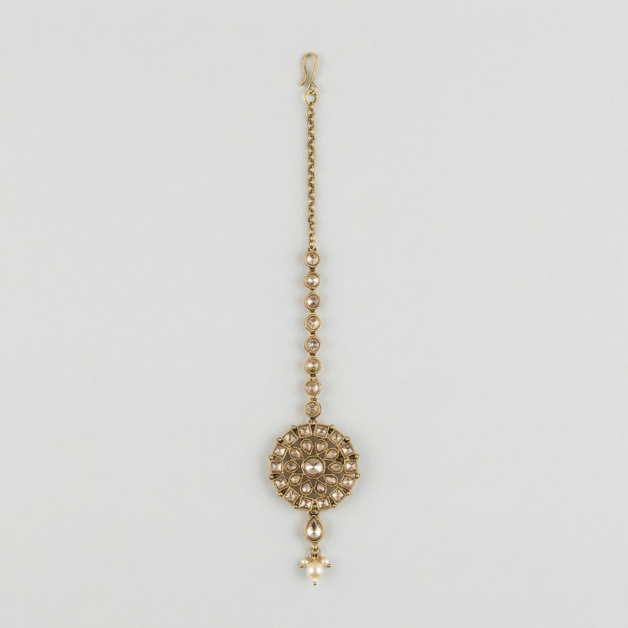 Classic Noor Round Tikka antique gold round mandala maang tikka with champagne stones on gray background