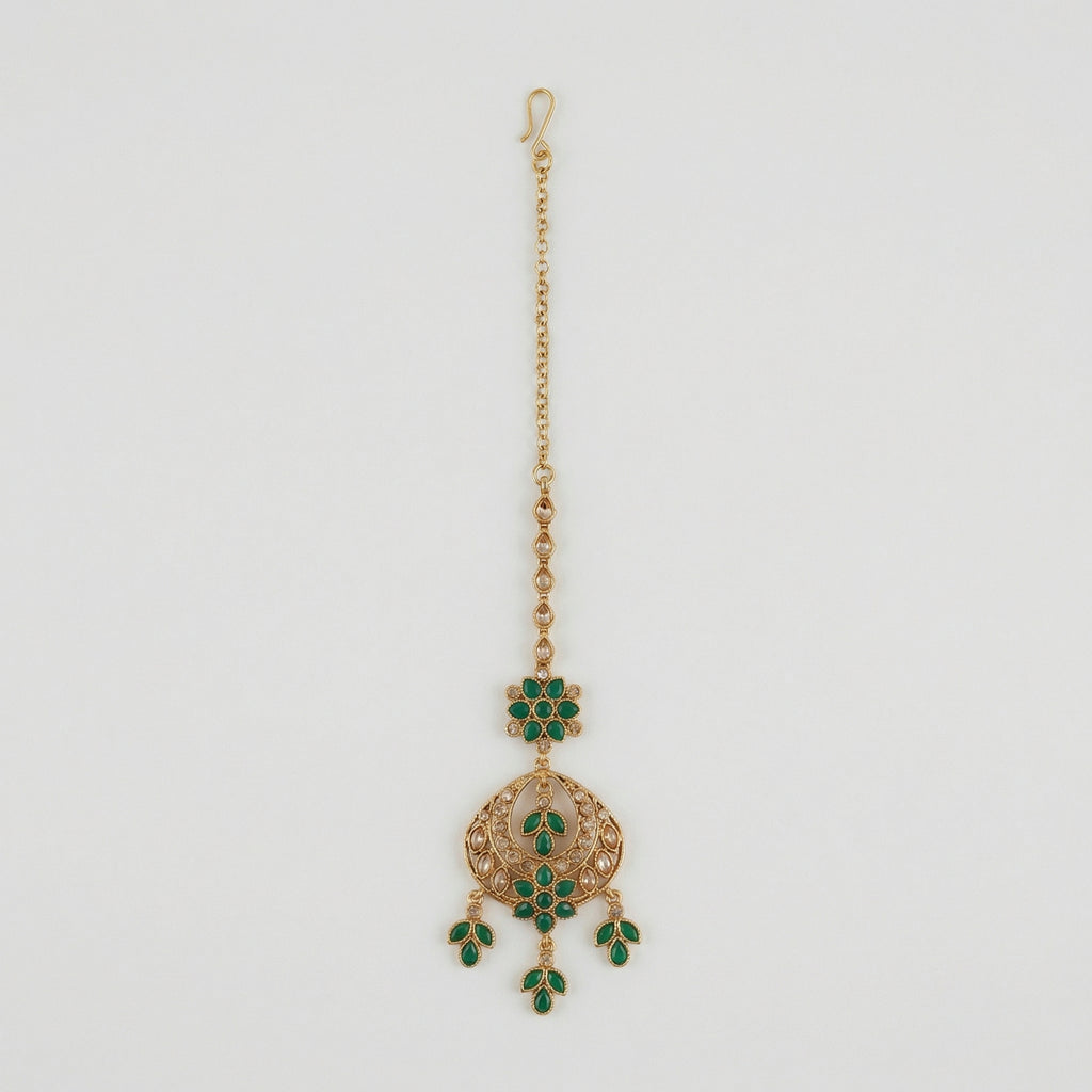 Verdant Glow Kundan Tikka gold maang tikka with green stones and clear crystal crescent on gray background
