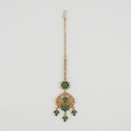 Verdant Glow Kundan Tikka gold maang tikka with green stones and clear crystal crescent on gray background
