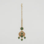 Verdant Glow Kundan Tikka gold maang tikka with green stones and clear crystal crescent on gray background