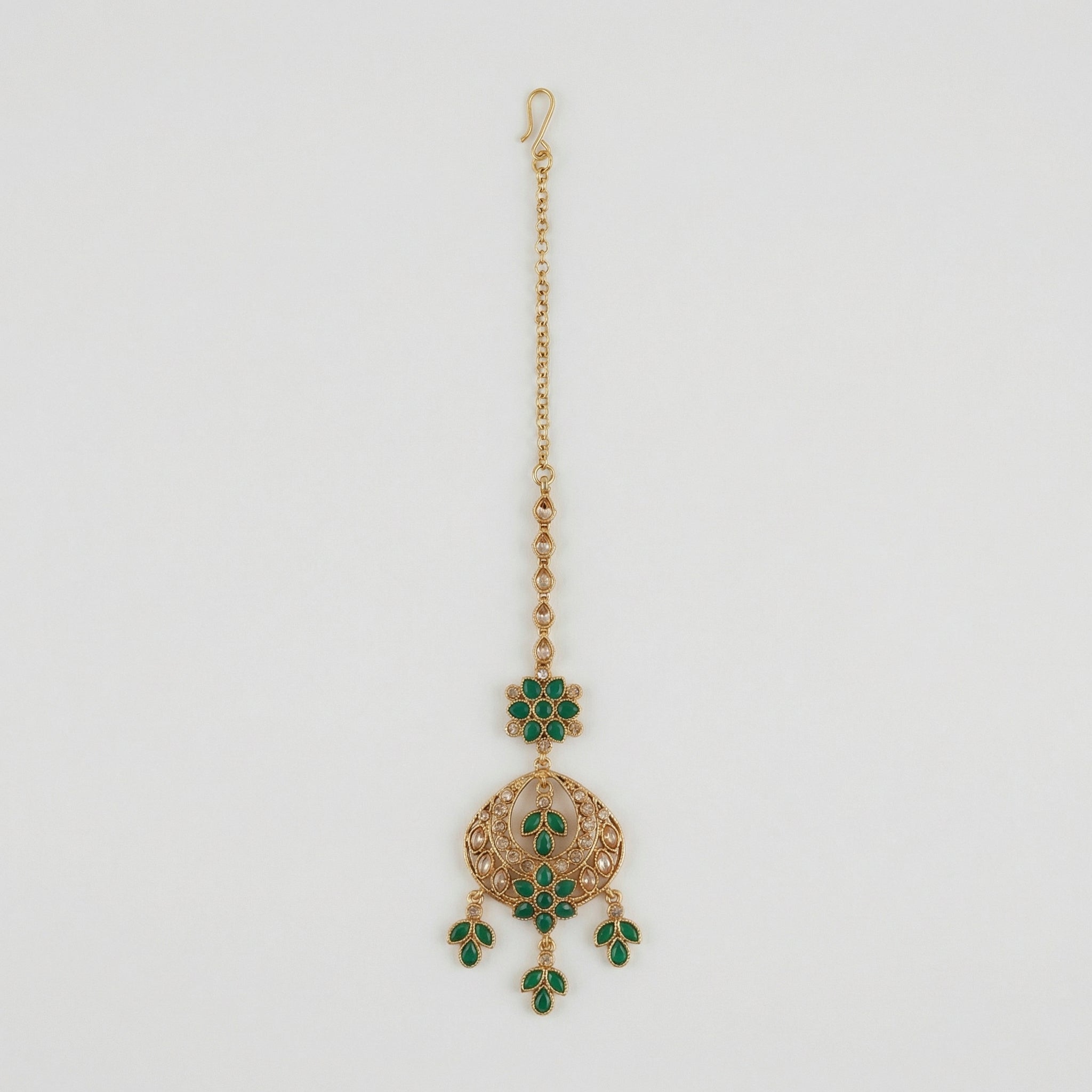 Verdant Glow Kundan Tikka gold maang tikka with green stones and clear crystal crescent on gray background