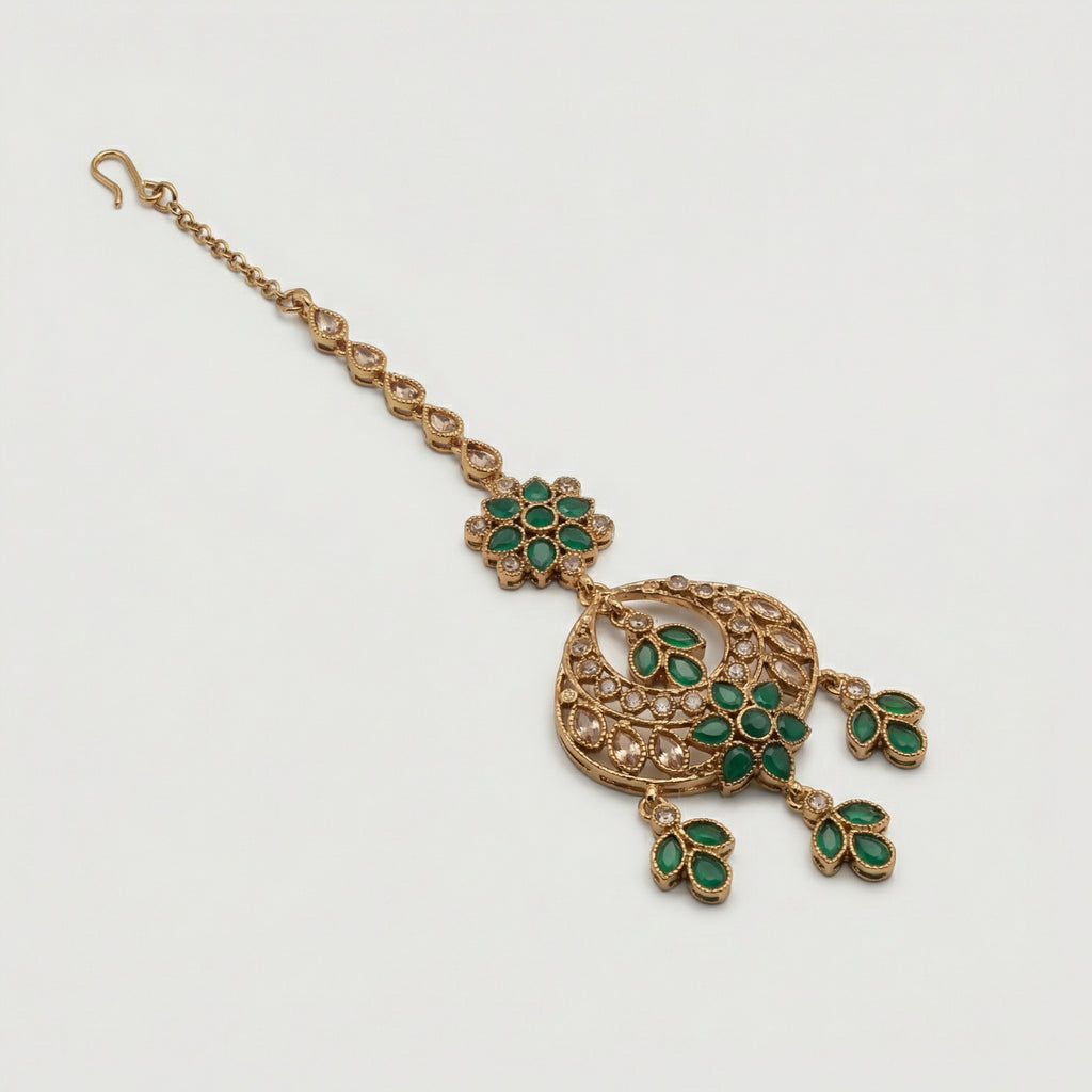Verdant Glow Kundan Tikka detail showing green floral link, pavé crescent, and triple-leaf charms