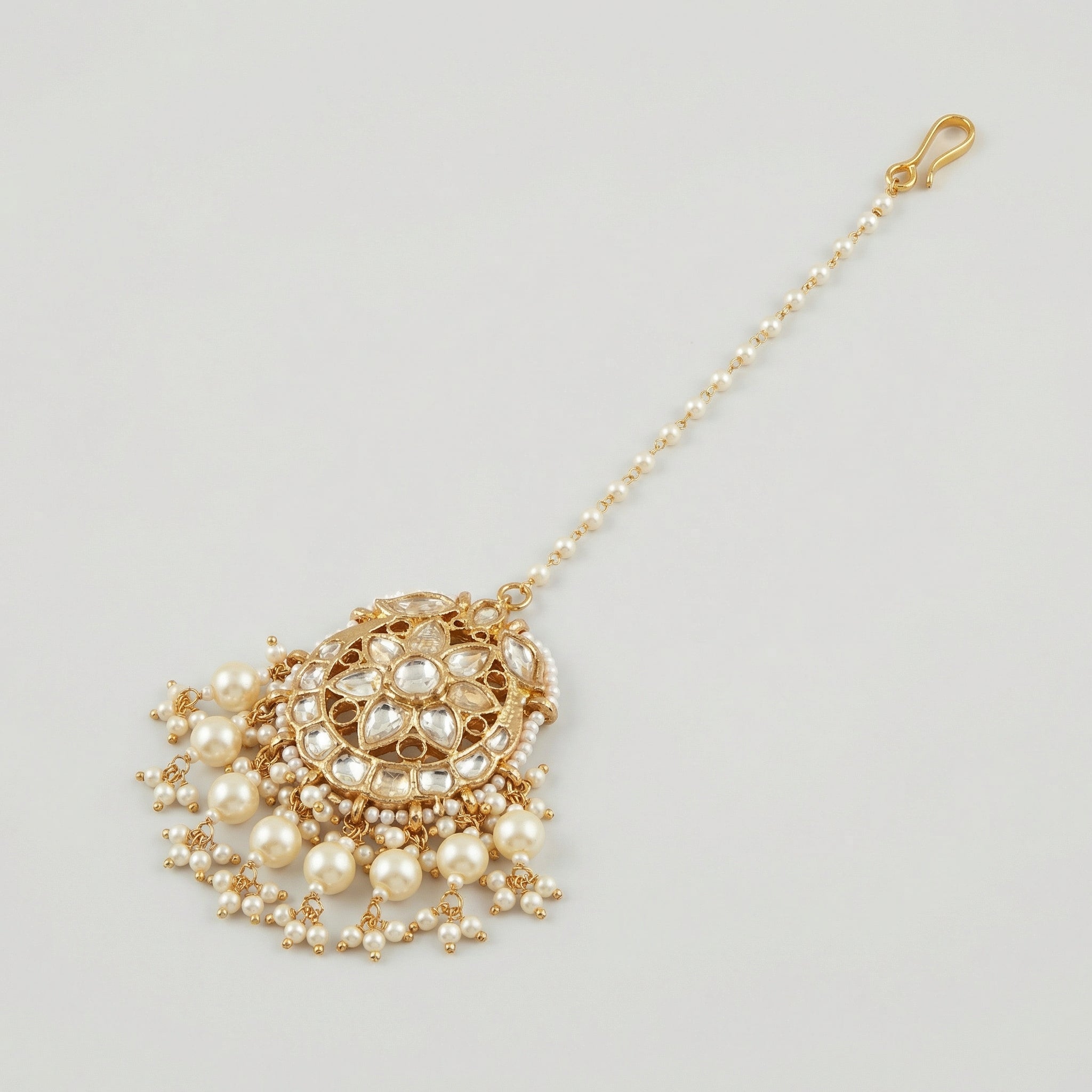 Luna Pearl Kundan Tikka detail showing pearl strand, clear stone floral center, and pearl drop fringe